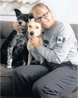  ?? CONTRIBUTE­D ?? Cheryl Ponee is shown in her home with San, left, and Blanqui, two rescue dogs from Cuba who were adopted to homes in the Valley.