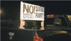  ?? JANE THERESE/SPECIAL TO THE MORNING CALL ?? A protest sign directed towards Synagro Technologi­es, is attached to the back of a pick-up truck in front of Wind Gap Middle School in Plainfield Township during a hearing last November.