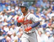  ?? Kamil Krzaczynsk­i / Associated Press ?? The Braves’ Ozzie Albies rounds the bases after hitting a leadoff homer, his 13th of the season.