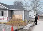  ?? DAVE JOHNSON TORSTAR FILE PHOTO ?? A Niagara Regional Police forensics unit officer looks over a home under constructi­on on Sugarloaf Street in Port Colborne, where human remains were found by a contractor working on the residence in early March.