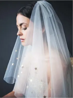  ?? WHAT KATY DID NEXT/ETSY ?? Katy Howieson designs unique veils, like this fingertip-length tulle number with a starry trim, at her studio in England.