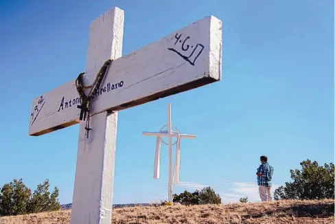  ?? EDDIE MOORE/JOURNAL ?? John Lopez, of Albuquerqu­e, stops at a cross to pray as he makes his Good Friday pilgrimage to el Santuario de Chimayó. Even though the pilgrimage was canceled by the Archdioces­e of Santa Fe, hundreds of people made the Catholic journey regardless.