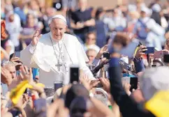  ?? ANDREW MEDICHINI/ASSOCIATED PRESS ?? Pope Francis leaves at the end of a canonizati­on ceremony in St. Peter’s Square at the Vatican Sunday. Francis declared two men saints at a Mass in St. Peter’s Square before tens of thousands of pilgrims.