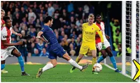  ??  ?? Comedy of errors: Pedro closes in to finish off Eden Hazard’s cross but his shot hits the post and rebounds into the face of Slavia’s Simon Deli for an unfortunat­e own goal that left Pedro smiling and Deli reeling