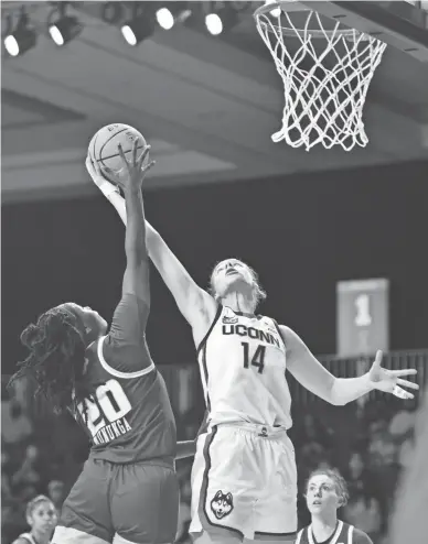  ?? KNOWLES/BAHAMAS VISUAL SERVICES VIA AP
DONALD ?? UConn's forward Dorka Juhasz, right, and South Florida forward Bethy Mununga fight for the ball Sunday.