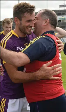  ??  ?? Manager Seamus McEnaney congratula­tes defender Brian Malone.