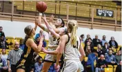  ?? JEFF GILBERT / CONTRIBUTE­D ?? Centervill­e’s Kaitlyn Palomino shoots over Sidney’s defense in the first half of Thursday night’s tournament game at Vandalia Butler. Centervill­e won 51-49 in overtime to reach the district final.