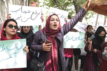  ?? — AFP photo ?? Members of Afghanista­n’s Powerful Women Movement take part in a protest in Kabul.