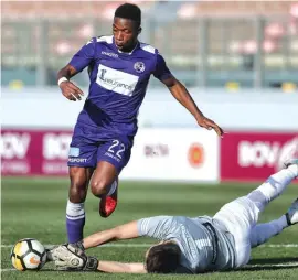  ??  ?? Lija Athletic goalkeeper Jonathan Martinelli perfectly times his dive to thwart St. Andrews’ striker Kelmar Reid (L) Photo: Domenic Aquilina