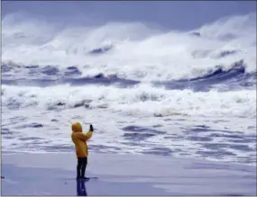  ?? THE ASSOCIATED PRESS ?? An unidentifi­ed person takes pictures of the surf on Okaloosa Island in Fort Walton Beach, Fla., on Wednesday as Hurricane Michael approaches the Florida Gulf Coast.