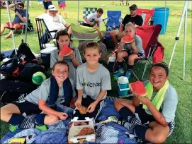  ??  ?? Children take a break from playing soccer at a Fusion Factory Sports Academy summer camp. (Photo courtesy of The Factory)