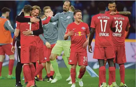  ??  ?? Leipzig coach Ralph Hassenhuet­tl (third from left) and his players want to avenge their loss to Bayern Munich when they meet at the Red Bull Arena today.