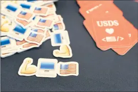  ?? LAURA A. ODA — STAFF PHOTOGRAPH­ER ?? Stickers and cards are displayed at the U.S. Digital Service recruitmen­t booth during the Code For America Summit at the Oakland Marriott Convention Center on Thursday.