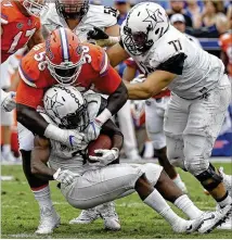  ?? JOHN RAOUX / ASSOCIATED PRESS ?? Vanderbilt’s Ralph Webb (bottom), the school’s all-time leading rusher, has often been harassed by the likes of Florida defensive lineman Tedarrell Slaton this season.