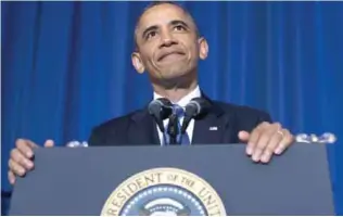  ?? —AFP ?? WASHINGTON: US President Barack Obama listens as a protester shouts during a speech about his administra­tion’s drone and counterter­rorism policies, as well as the military prison at Guantanamo Bay, at the National Defense University in Washington.