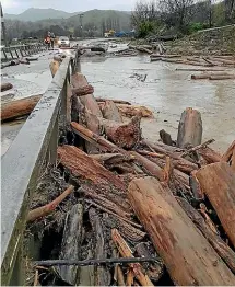  ??  ?? ABOVE: Wigan Bridge, on Tauwharepa­rae Rd outside of Gisborne, is covered with debris and flooded over on June 11.