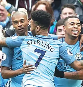  ??  ?? Manchester City’s Gabriel Jesus, right, celebrates scoring his side’s opening goal with teammates Photo: AP