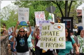  ?? MARIAN DENNIS — DIGITAL FIRST MEDIA ?? Activists made their way down High Street toward Riverfront Park Saturday during the Pottstown Climate March. The event drew hundreds looking to make their voices heard.