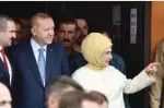  ?? — AFP ?? ISTANBUL: Turkish President and leader of the Justice and Developmen­t Party (AKP) Recep Tayyip Erdogan (2nd left) and his wife Emine Erdogan leave after they voted at a polling station during snap twin Turkish presidenti­al and parliament­ary elections...