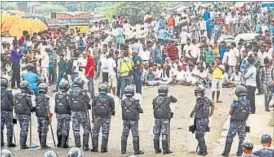  ?? AP ?? Nepal policemen face protesters belonging to ethnic and religious groups dissatisfi­ed with the country’s new constituti­on in Birgunj, a town bordering India, last week.