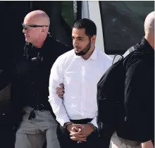  ?? JUSTIN TANG THE CANADIAN PRESS ?? Awso Peshdary, who is accused of recruiting for ISIL, is escorted by police as he arrives for a hearing at the Supreme Court of Canada in Ottawa Monday.