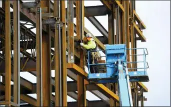  ?? SEAN KILPATRICK — THE CANADIAN PRESS VIA AP ?? A steel worker builds a structure in Ottawa, Ontario, Monday. President Donald Trump insisted Monday that he’s “not backing down” on his plan to impose stiff tariffs on imported steel and aluminum despite anxious warnings from House Speaker Paul Ryan...