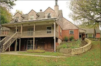  ??  ?? A slate patio is accessible from one of the two first-level main bedrooms, and the tiered garden and stone steps lead to the lower-level slate patio. The wood deck is accessible from the living room while the back yard is accessible from the lower-level recreation room.