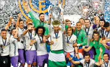  ??  ?? Sergio Ramos lifts the trophy after Real Madrid won the UEFA Champions League final football match against Juventus at The Principali­ty Stadium in Cardiff.