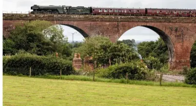  ?? HOWARD ROUTLEDGE ?? No. 60103 Flying Scotsman crosses Wetheral Viaduct with the ‘Waverley’ on August 21.