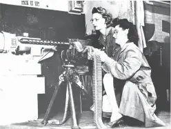  ?? Associated Press file photo ?? In this April 30, 1943, file photo, Mae Zelisnky shoots as Betty O’Beda feeds a 30-caliber rifle during an ammunition test at Remington Arms Company. The gun was fired down an enclosed range into a sandpit. Remington filed for bankruptcy protection...