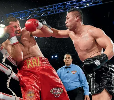  ?? PHOTO: PHOTOSPORT ?? Joseph Parker goes on the attack against Romania’s Razvan Cojanu during his unanimous points win to retain his WBO world heavyweigh­t title.