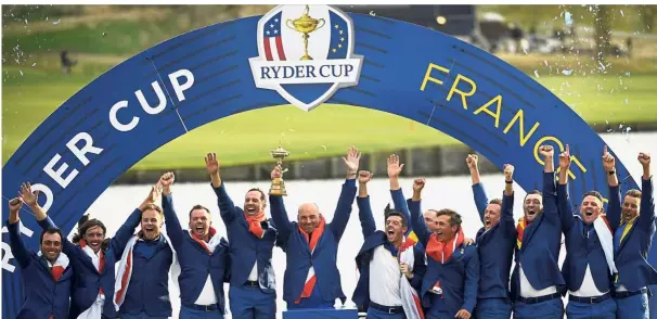  ?? — AFP ?? Europe Ryder Cup team (from left) Francesco Molinari, Tommy Fleetwood, Tyrrell Hatton, Paul Casey, captain Thomas Bjorn, Rory McIlroy, Alex Noren, Thorbjorn Olesen, Ian Poulter, Jon Rahm, Justin Rose and Henrik Stenson celebratin­g with the trophy after defeating the United States at Le Golf National in Paris on Sunday.