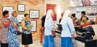  ?? Picture: ATU RASEA ?? Invited guest being served at the new Burger King outlet at the Challenge Plaza, Laucala Beach after the soft opening yesterday.