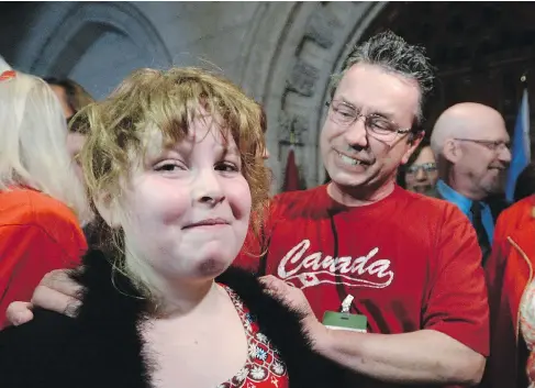  ?? SEAN KILPATRICK / THE CANADIAN PRESS ?? Charlie Lowthian-Rickert, who is transgende­r, with father Chris Rickert following the announceme­nt of gender identity legislatio­n this week.