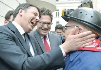  ?? — Reuters ?? Italy’s former prime minister Matteo Renzi meets with Mario Ziccardi, a former miner at le Bois du Cazier, before a news conference in Brussels, Belgium, on Friday.