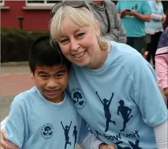  ??  ?? Ky Busher and Mary Ryan who were cheering on Tommy Walsh as he finished his 500km run to raise money for the Rainbow Unit in Scoil Mhuire by running the the last 10km and crossing the line at the school.