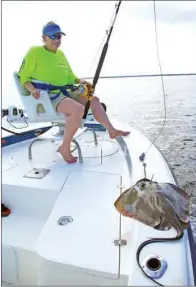  ??  ?? KEITH SUTTON/ CONTRIBUTI­NG PHOTOGRAPH­ER Catching gigantic fish requires gigantic baits. Here, Theresa Sutton prepares to drop a big stingray that will entice a 275-pounder for her.