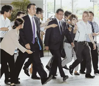  ?? AP.PHOTO ?? HIGH ALERT: Japanese Foreign Minister Taro Kono, center, arrives at the prime minister’s official residence in Tokyo this morning after a report of a North Korean missile launch. South Korea’s military said North Korea fired an unidentifi­ed missile...