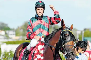  ?? Photo / Race Images ?? Craig Grylls celebrates riding Rocket Spade to victory in the New Zealand Derby.