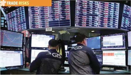  ?? — Reuters ?? Traders work on the floor at the New York Stock Exchange (NYSE) in New York City.