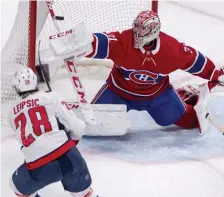  ?? AP ?? BLOCKERED ASIDE: Montreal Canadiens goaltender Carey Price makes a save on the Capitals’ Brendan Leipsic during second period in Montreal on Monday.