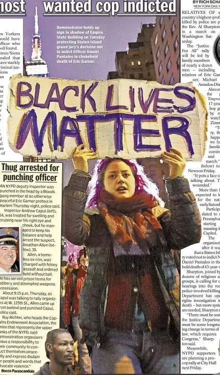  ??  ?? Demonstrat­or holds up sign in shadow of Empire State Building on Tuesday protesting Staten Island grand jury’s decision not to indict Officer Daniel Pantaleo in chokehold death of Eric Garner.