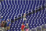  ?? The Associated Press ?? ■ Baseball fans stand during the singing of the National Anthem before the start of a game between the Miami Marlins and the Texas Rangers Thursday in Miami. Major League Baseball teams head into the final months of the regular season struggling to fill the stands now, even without pandemic-related attendance restrictio­ns.