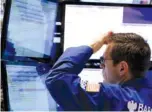  ?? AP PHOTO/RICHARD DREW ?? Specialist Charles Solomon works at his post on the floor of the New York Stock Exchange in December 2014. The S&amp;P 500, the stock market’s benchmark index, has climbed in the 12 months after each of the midterm elections going back to 1946.