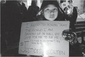  ?? METROLAND MELINDA CHEEVERS ?? Alexis Isaacs, 8, of Fort Erie, holds a handmade sign during the Feb. 14 Vigil held for Colten Boushie on the front steps of St. Catharines City Hall.