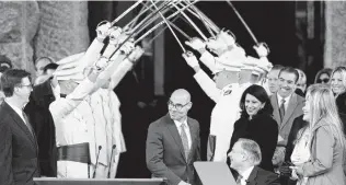  ?? Eric Gay / Associated Press ?? Lt. Gov. Dan Patrick, left, seen with House Speaker Dennis Bonnen and Gov. Greg Abbott during inaugurati­on ceremonies Tuesday, said in his speech that “we have to put our teachers first.”