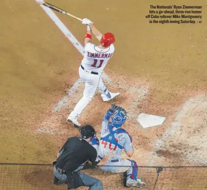  ??  ?? The Nationals’ Ryan Zimmerman hits a go- ahead, three- run homer off Cubs reliever Mike Montgomery in the eighth inning Saturday. | AP