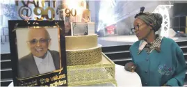  ?? Picture: Nigel Sibanda ?? LOVED. Trade unionist Rita Ndzanga reads a message from Ahmed Kathrada’s birthday cake at Sandton Convention Centre on Saturday.