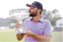  ?? MICHAEL WYKE/ASSOCIATED PRESS ?? Stephan Jaeger kisses the trophy after his win in the final round of the Houston Open golf tournament on Sunday.