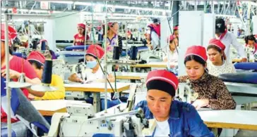  ?? SAHIBA CHAWDHARY ?? Workers stitch clothes at a garment factory in Sihanoukvi­lle’s Special Economic Zone.